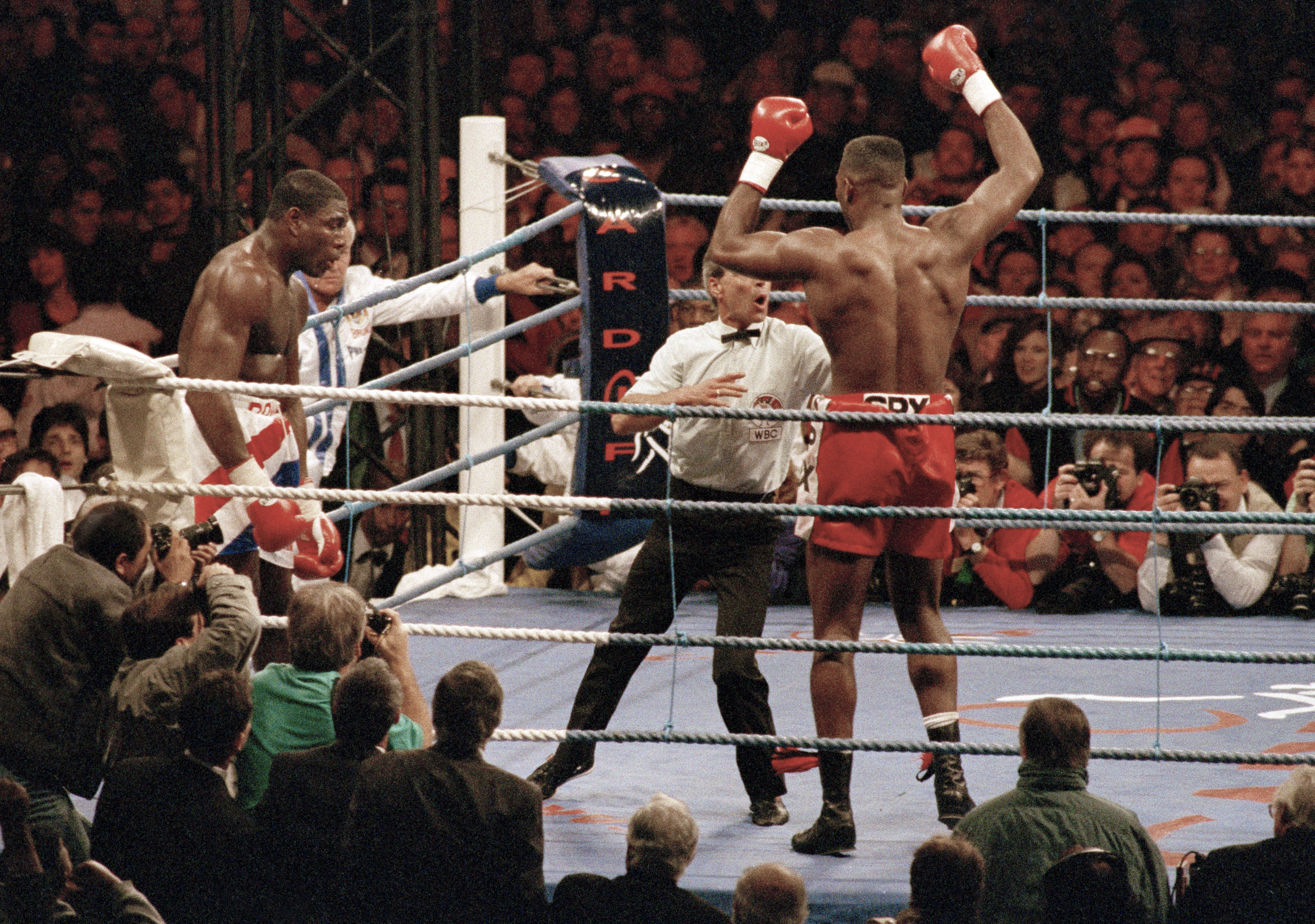 Frank Bruno of Great Britain (left) is stopped in the seventh round as referee Mickey Vann steps in, giving the WBC World heavyweight title to Lennox Lewis of Great Britain