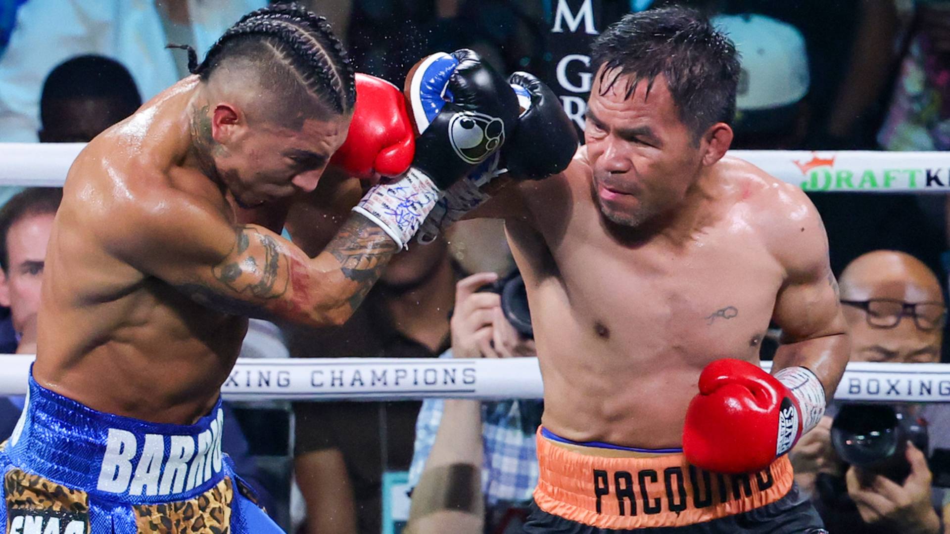 Manny Pacquiao (R) punches Mario Barrios during their WBC welterweight title fight