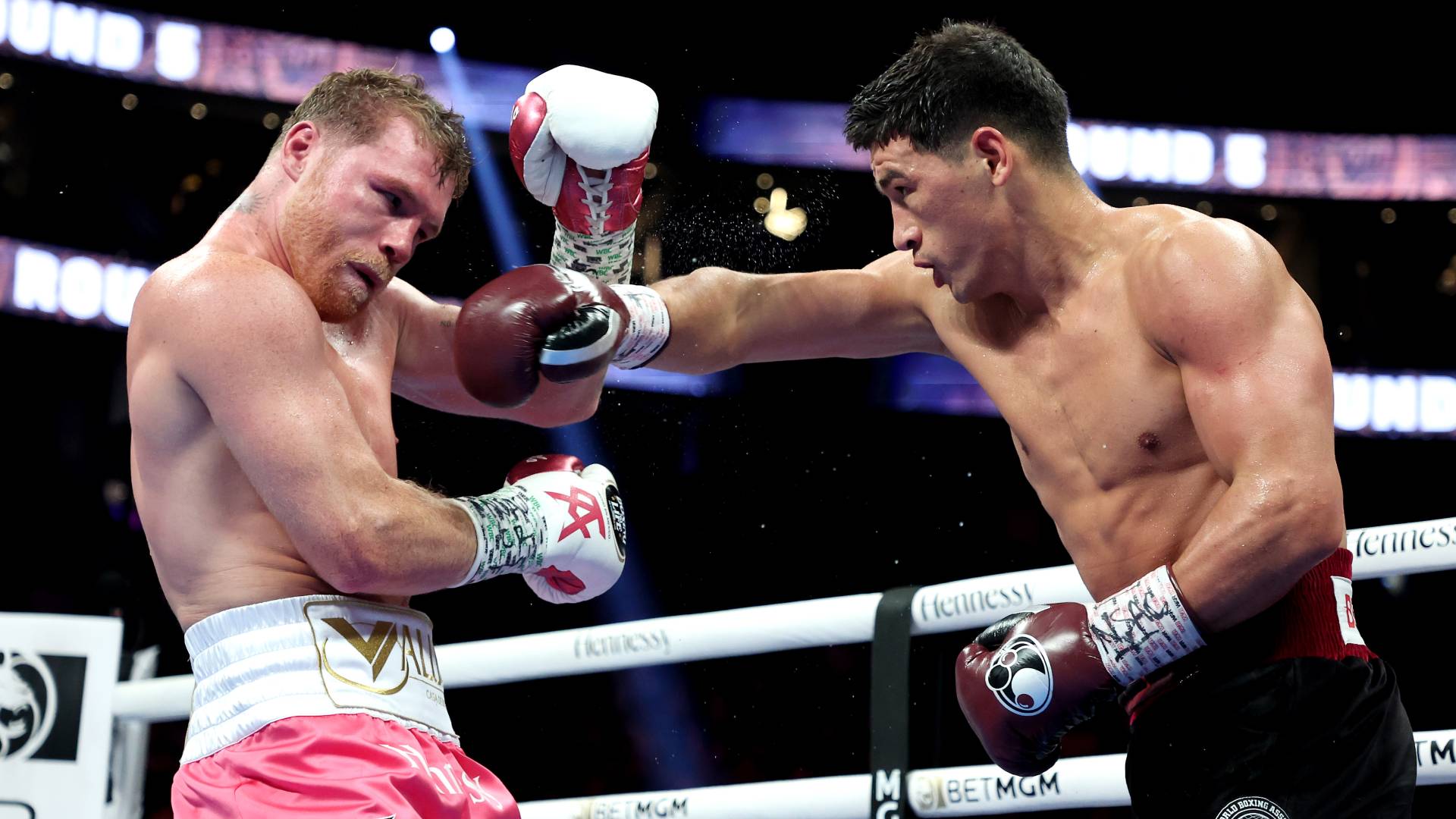 mitry Bivol (R) exchanges punches with Canelo Alvarez