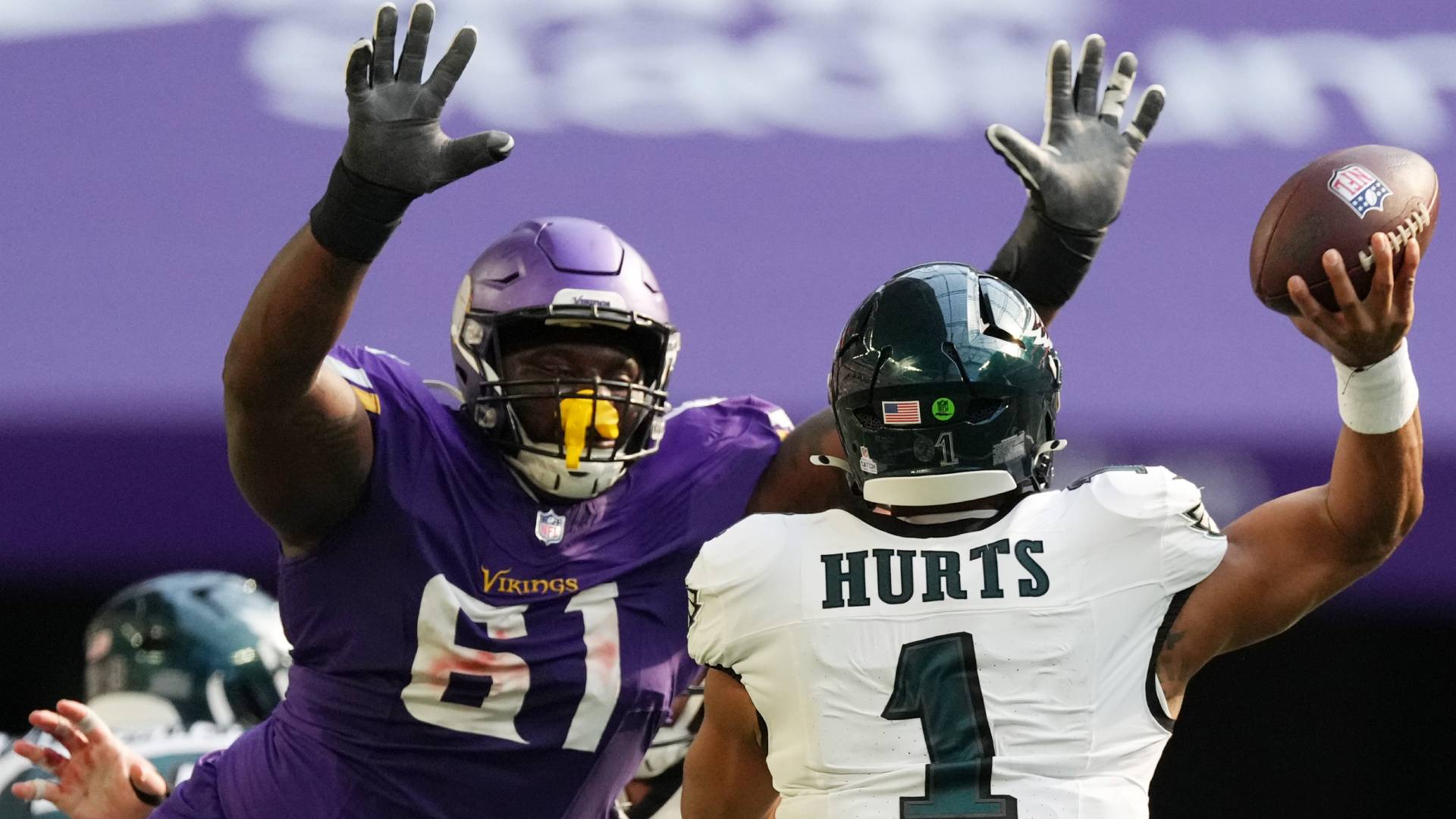 Philadelphia Eagles quarterback Jalen Hurts (1) throws under pressure from Minnesota Vikings defensive lineman Jalen Redmond