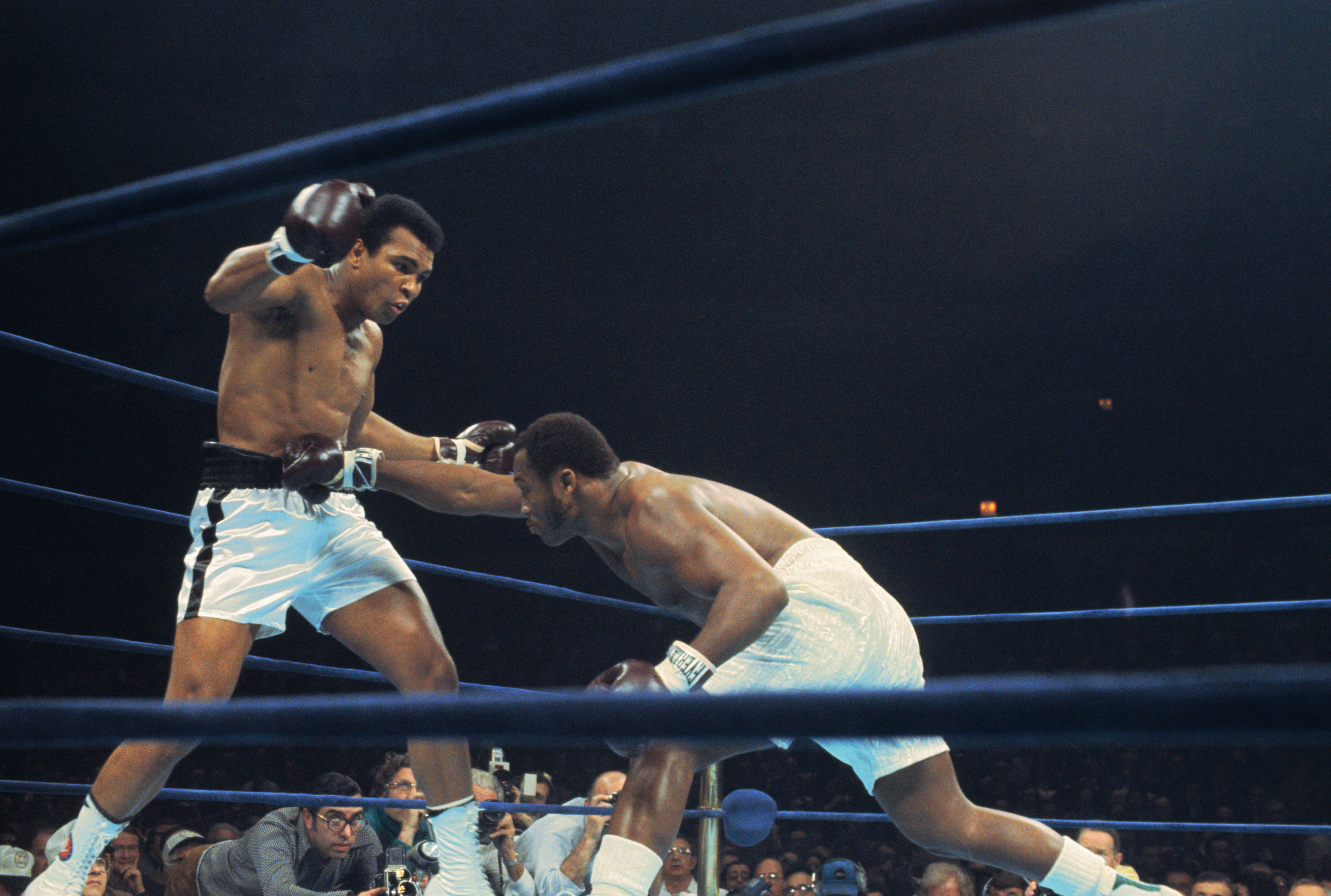Joe Frazier (right) crouch's and lands a right to the stomach of Muhammad Ali in bout here January 28