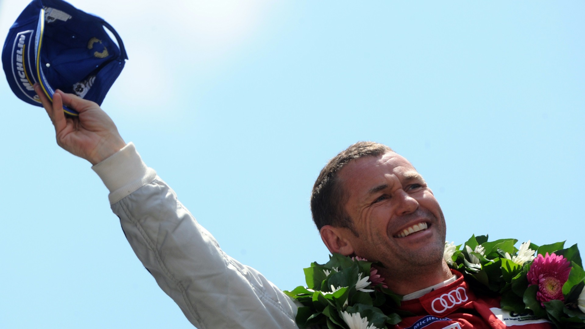 Danish driver Tom Kristensen celebrates on the podium after coming in second in the 82nd 24 Hours of Le Mans endurance race on June 15, 2014, in Le Mans