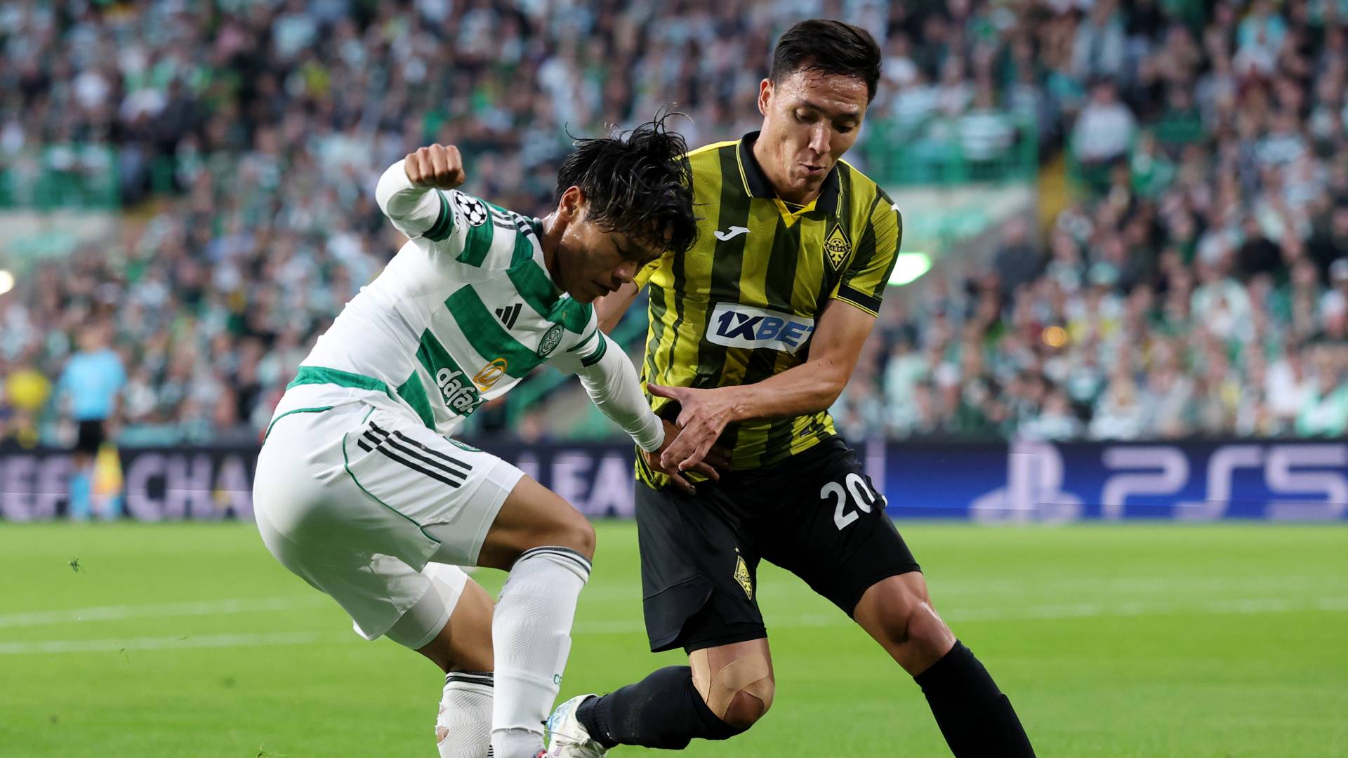 Reo Hatate of Celtic challenges for the ball with Yerkin Tapalov of Kairat Almaty