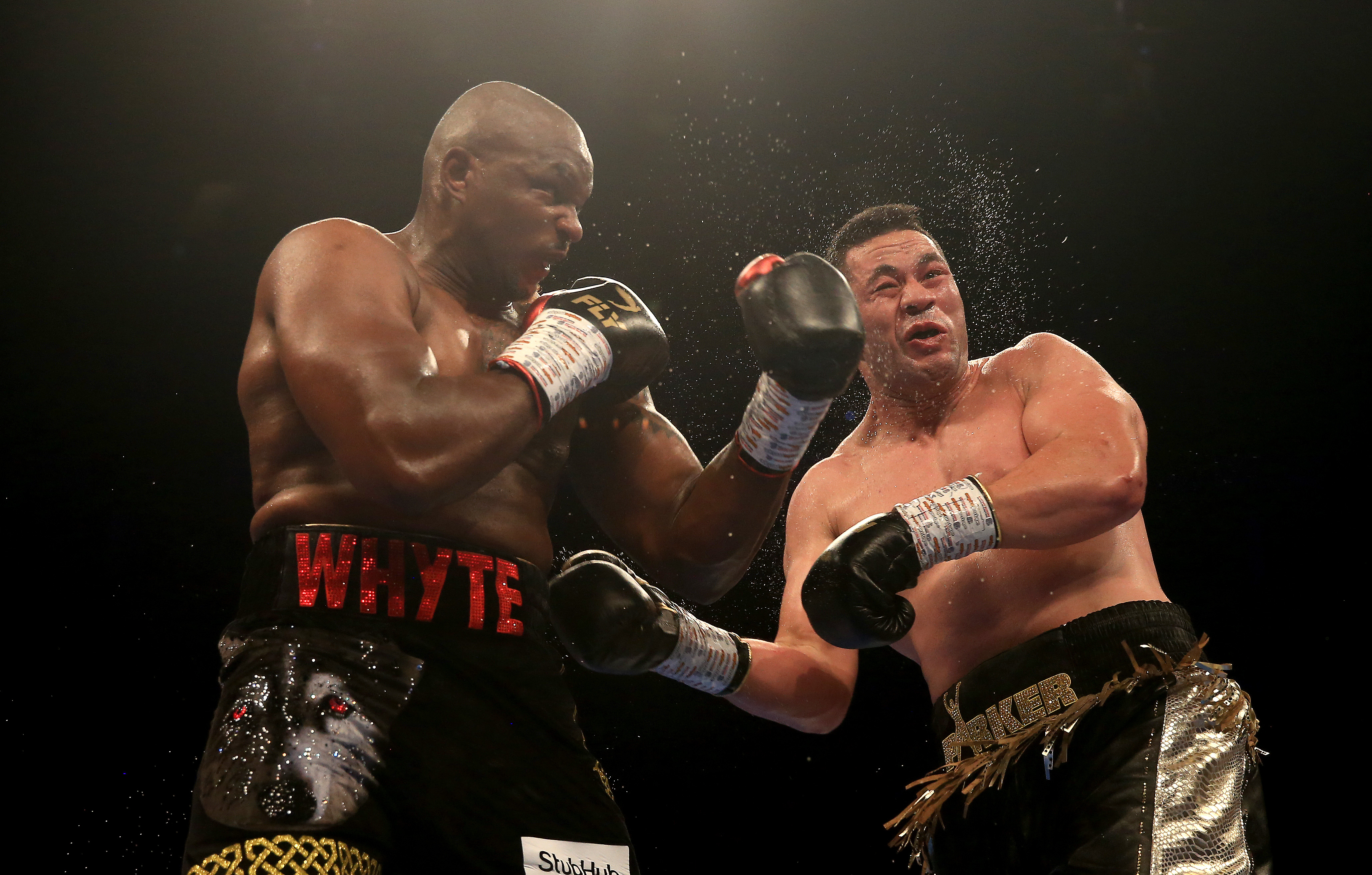 Dillian Whyte punches Joseph Parker during the Heavyweight