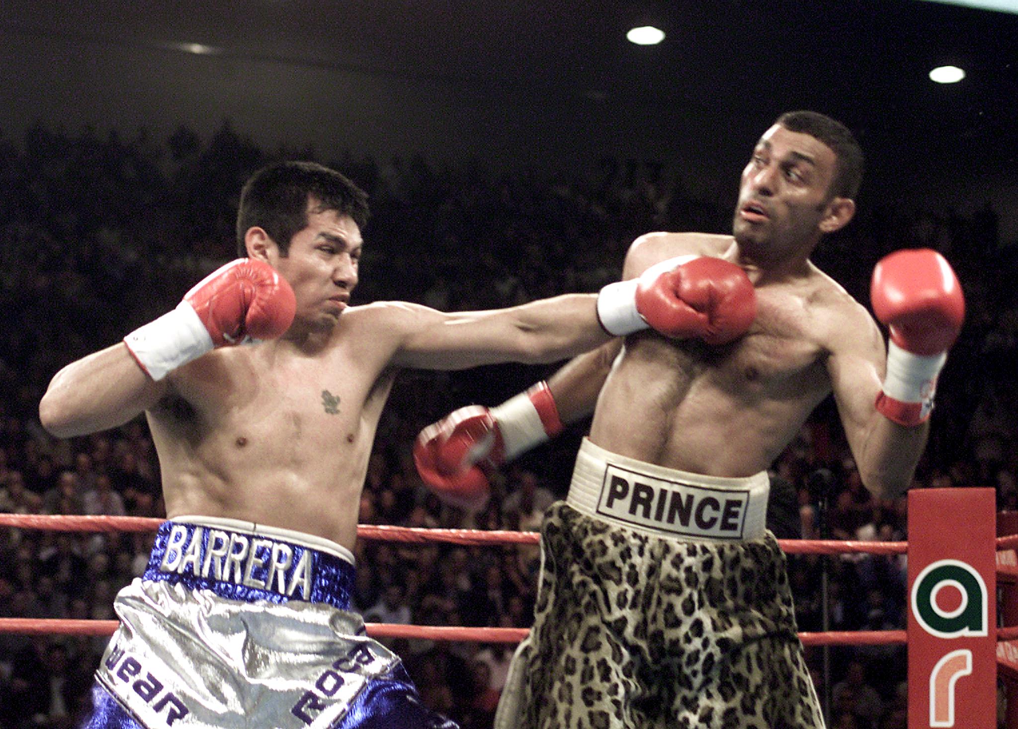 wo-time world champion Marco Antonio Barrera (L) from Mexico scores a left against three-time world champion Prince Naseem Hamed