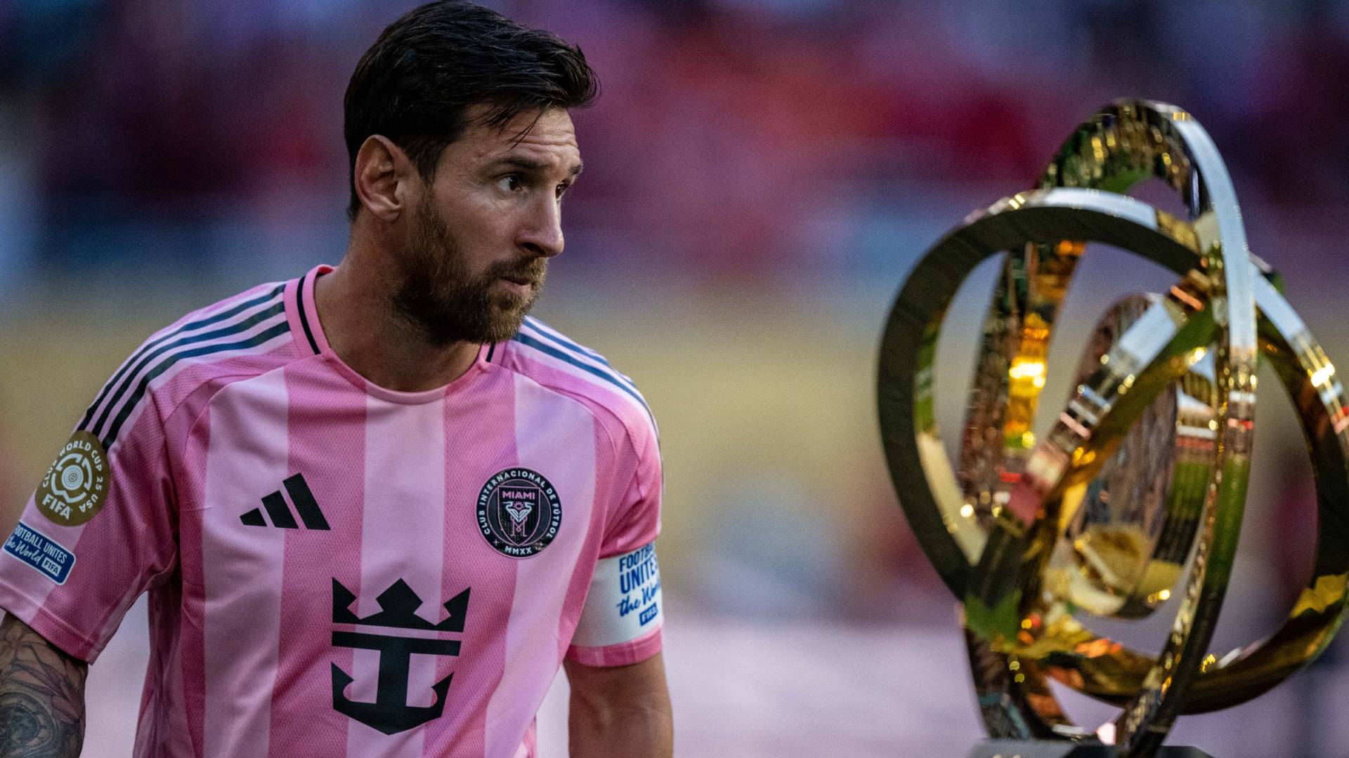 Lionel Messi of Inter Miami walks next to the FIFA Club World Cup Trophy