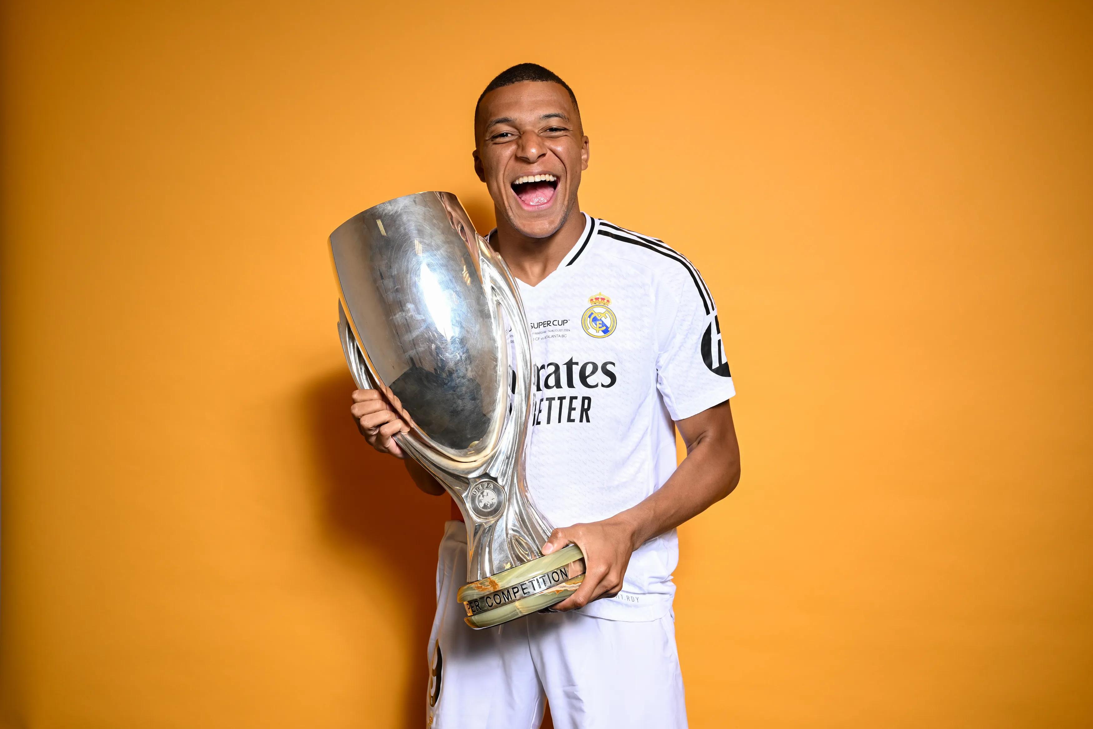 transform-5853e804-a7ac-47a5-8445-83ac1b61af02-WARSAW-POLAND-AUGUST-14-Kylian-Mbappe-of-Real-Madrid-poses-with-the-UEFA-Super-Cup-Trophy-during-the-winners-shoot-after-winning-the-the-UEFA-Super-Cup-2