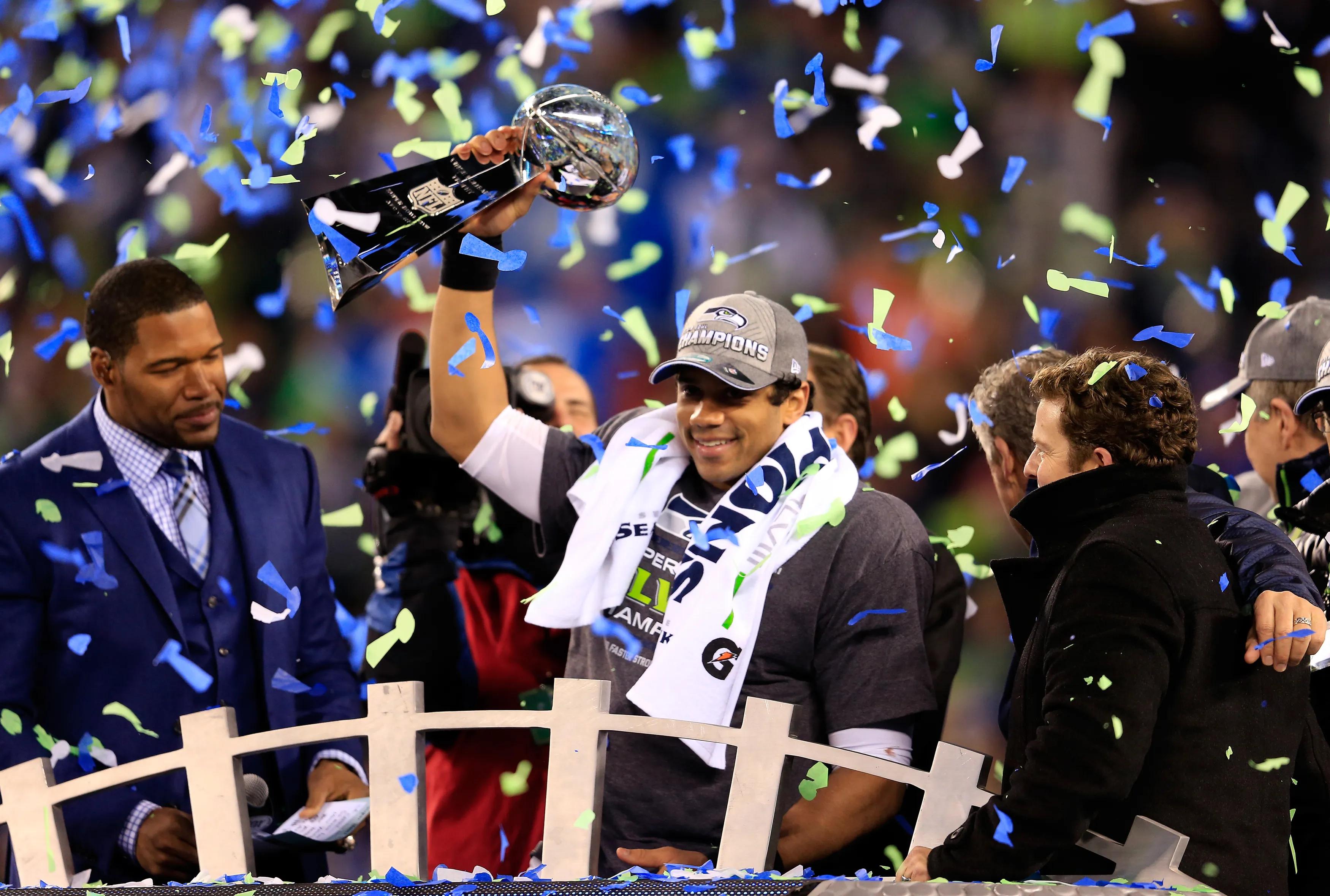 transform-834f2e69-1e22-41b3-88cf-40545e14336d-Russell-Wilson-celebrates-with-the-Vince-Lombardi-trophy-after-the-Seattle-Seahawks-beat-the-Denver-Broncos-43-8-in-Super-Bowl-XLVIII-at-MetLife-Stadium-